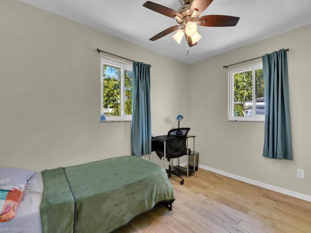 Bedroom featuring ceiling fan and hardwood / wood-style flooring