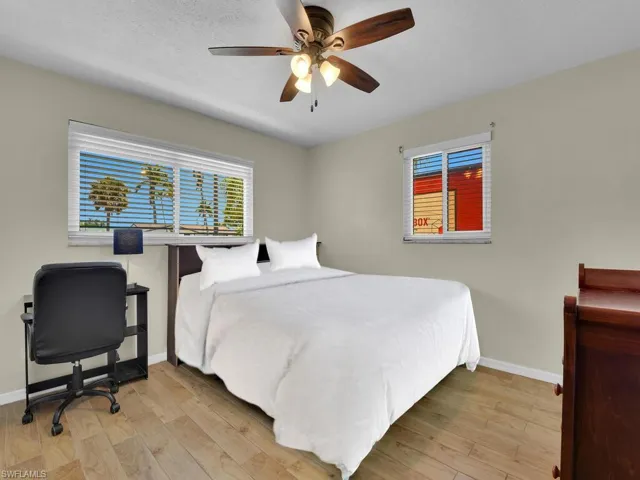 Bedroom with ceiling fan and light wood-type flooring