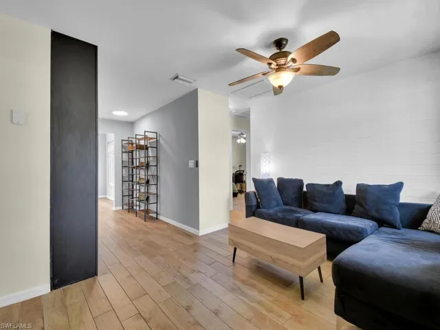 Living room featuring ceiling fan and light wood-type flooring