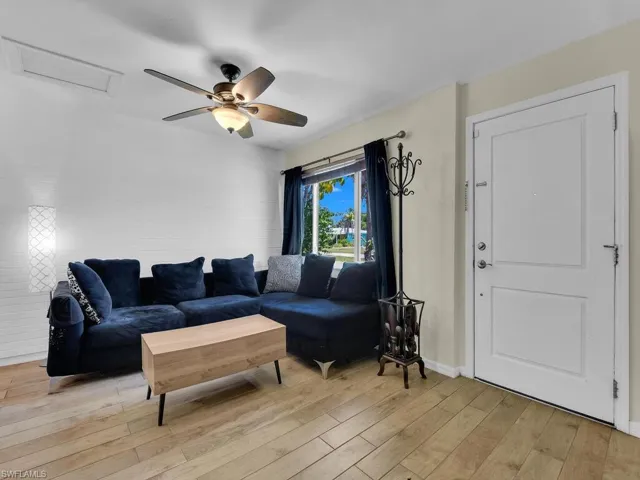 Living room featuring light hardwood / wood-style floors and ceiling fan