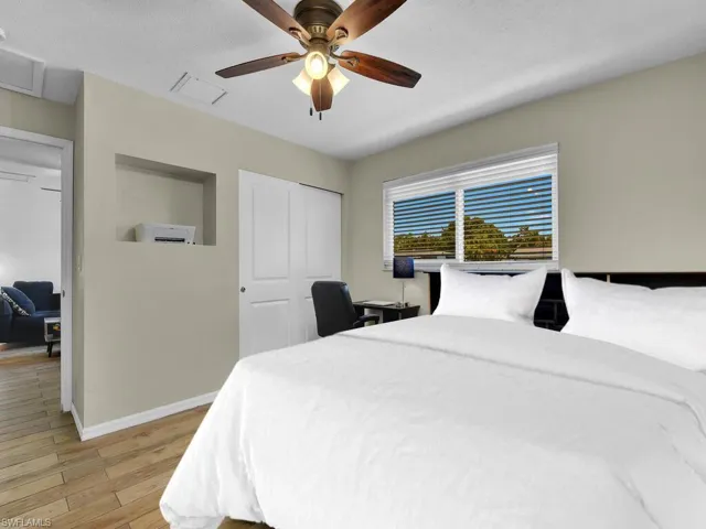 Bedroom with ceiling fan and light hardwood / wood-style flooring