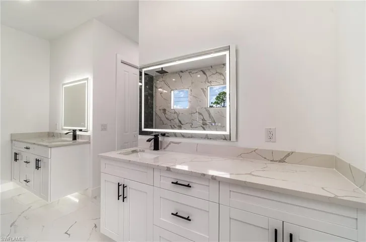 Primary Bathroom with 2 separate floating sinks with under cabinet lights and frameless Anti-Fog LED vanity mirrors.