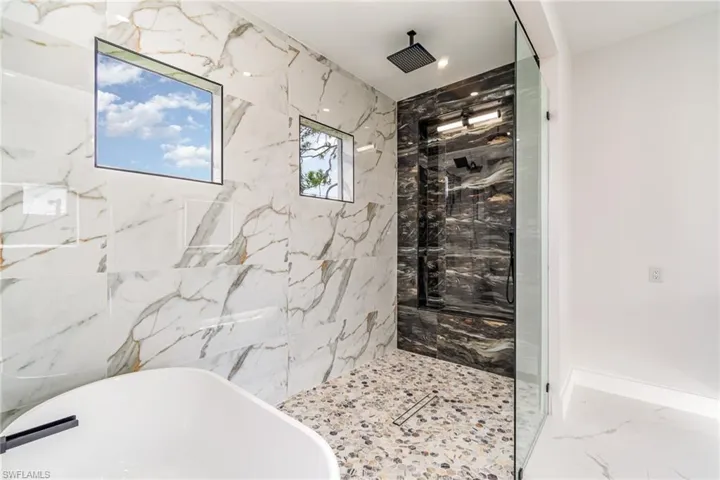 Primary Bathroom with freestanding tub. All tiled.