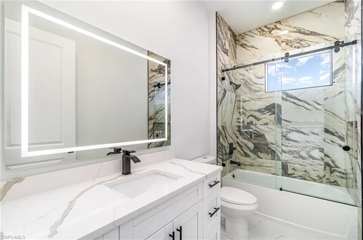 Guest bathroom #2 with Anti-Fog LED light vanity mirror, tiled, shower/bathtub.