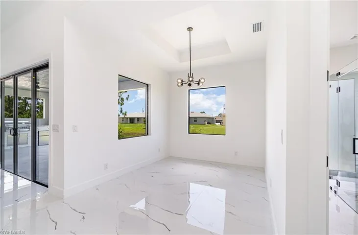 Dining room featuring chandelier and tray ceiling