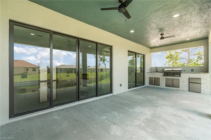 View of patio with grilling area, recessed lights, ceiling fan, and exterior kitchen