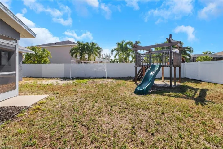 View of yard featuring a fenced backyard and a playground