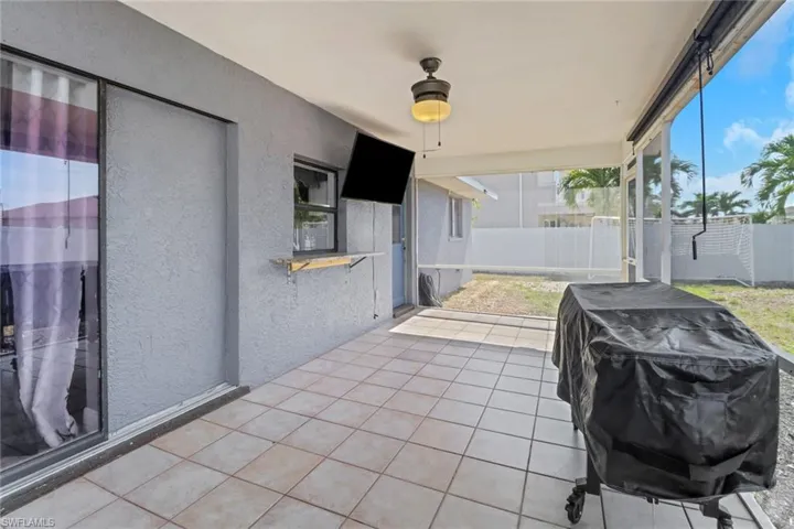 View of patio with a fenced backyard, a grill, and ceiling fan