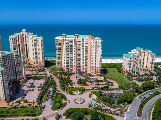 Birds eye view of property with a view of the beach and a water view