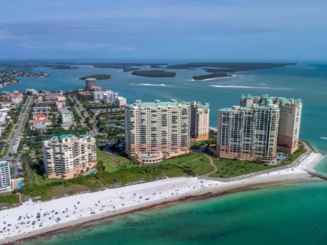 Bird's eye view featuring a water view and a beach view