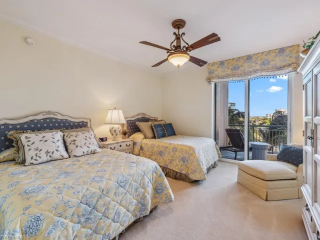Carpeted bedroom featuring access to exterior, ceiling fan, and ornamental molding