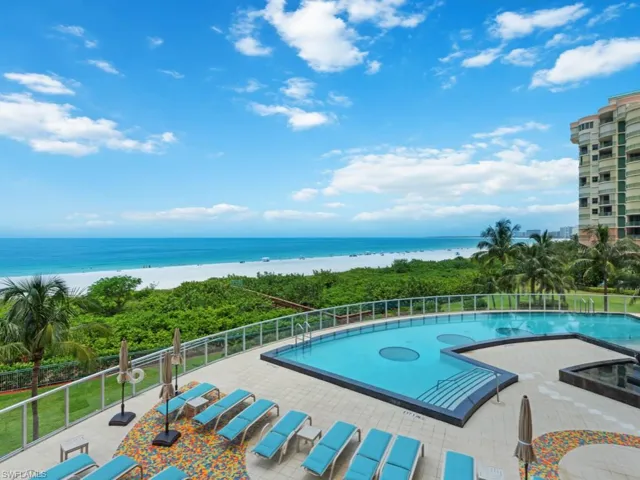 View of swimming pool with a water view and a patio