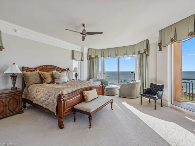 Bedroom featuring carpet flooring, ceiling fan, a water view, and access to outside
