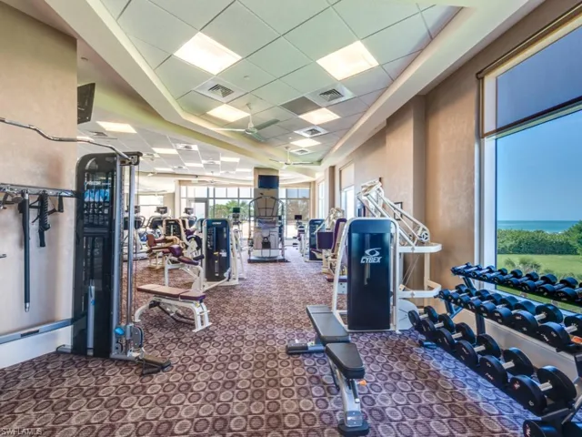 Exercise room with a drop ceiling and carpet floors