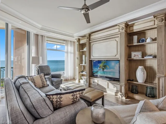 Living room featuring ceiling fan, hardwood / wood-style floors, and ornamental molding