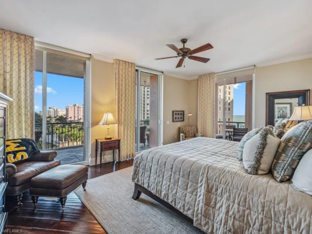 Bedroom featuring ceiling fan, ornamental molding, dark wood-type flooring, and access to outside
