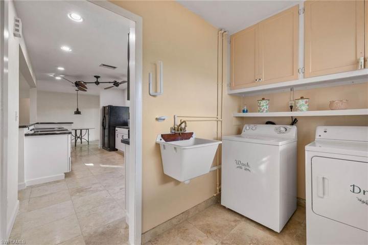Indoor laundry room with storage.