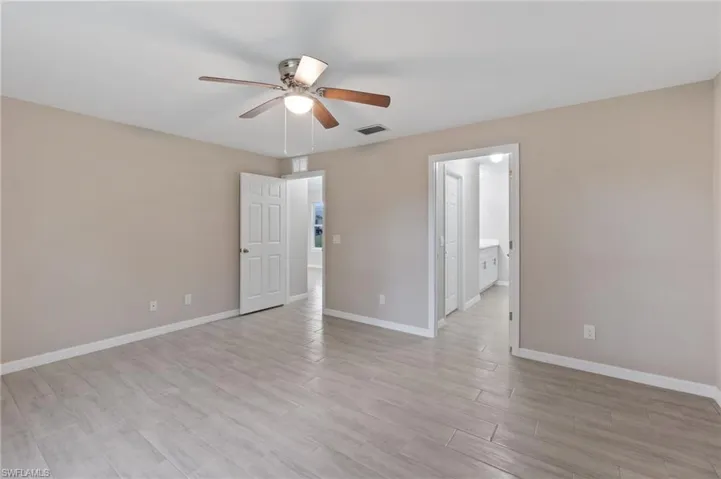 Empty room featuring light hardwood / wood-style flooring and ceiling fan