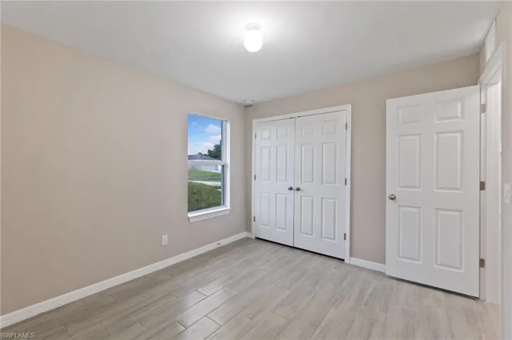 Unfurnished bedroom with a closet and light wood-type flooring