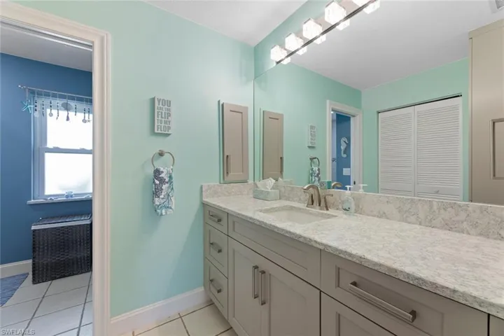 Remodeled Master Bath with consistent quartz countertops and new soft close cabinetry.