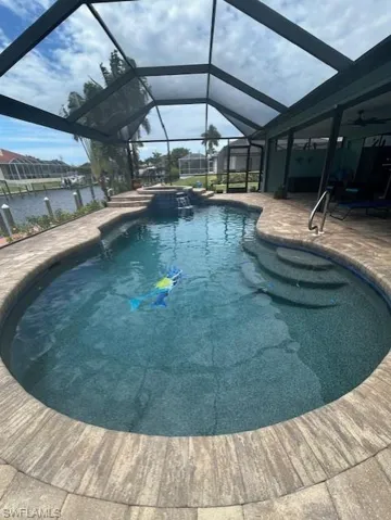 Sparkling blue Pebble Tec pool finish with inlaid dolphins & a mermaid
