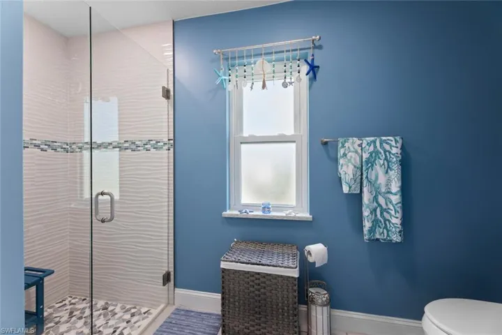 Bathroom featuring walk in shower and toilet