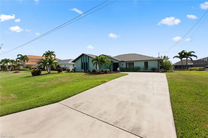 Tropical landscaping including two pineapple plants!