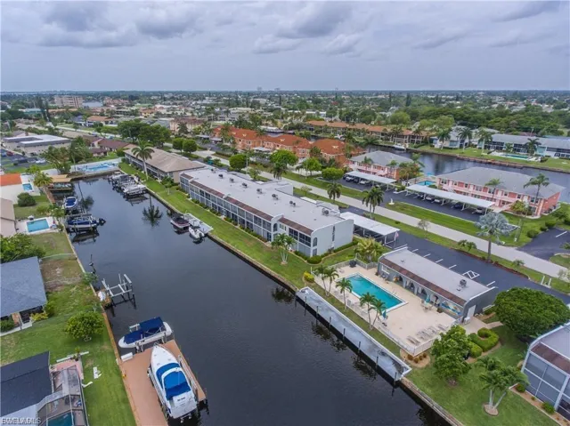 Aerial view of property and surrounding area featuring a nearby body of water