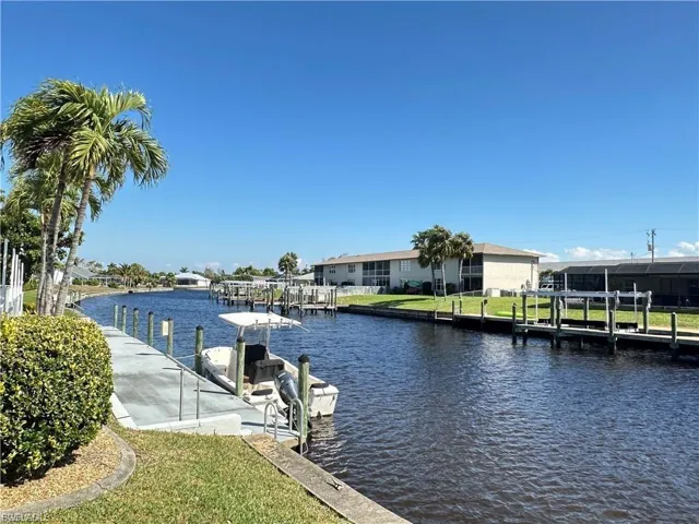 Dock featuring a water view and a lawn