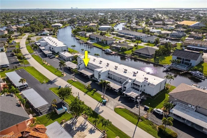 Aerial view of residential area featuring a nearby body of water