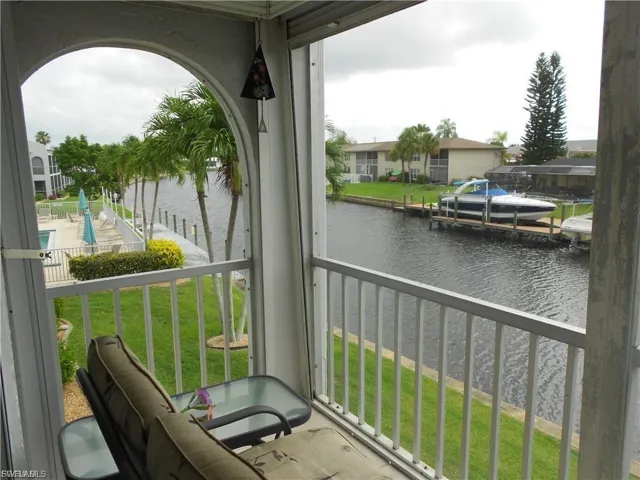Balcony with a water view and a dock