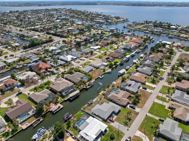 Aerial view of property's location featuring nearby suburban area and a nearby body of water