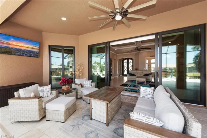 View of patio with an outdoor living space and ceiling fan