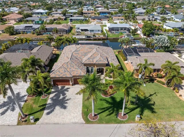Aerial view of residential area featuring a nearby body of water