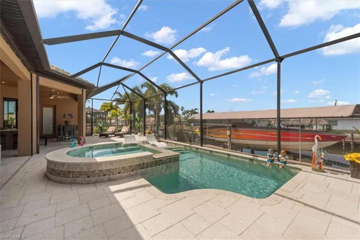 Integrated pool / hot tub with a patio area, a lanai, and a sunroom