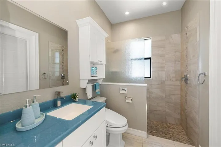 Full bath with a walk in shower and vanity