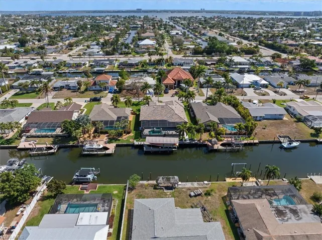 Aerial overview of property's location with a large body of water and nearby suburban area
