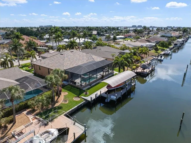 Aerial perspective of suburban area featuring a nearby body of water