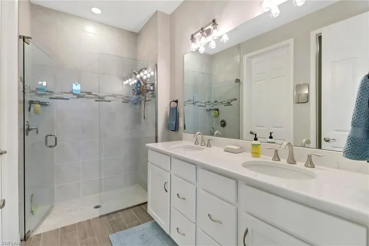 Bathroom with vanity and a shower with frameless shower door