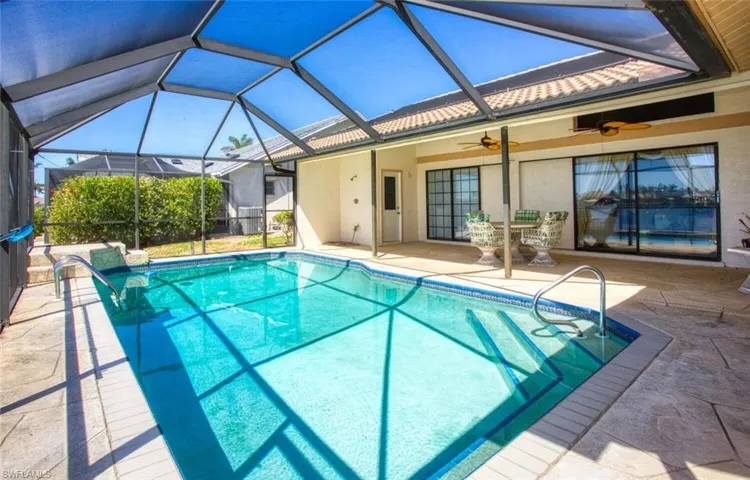 Outdoor pool with a patio, a lanai, and a ceiling fan