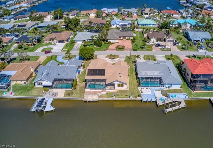 Drone / aerial view with a water view and a residential view