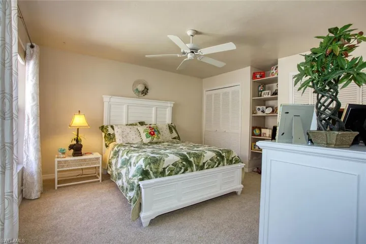 Bedroom featuring a ceiling fan, carpet, and a closet