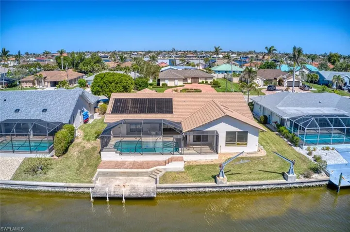 Birds eye view of property with a residential view and a water view