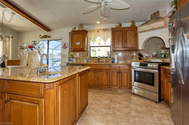 Kitchen featuring stainless steel appliances, brown cabinetry, and a sink