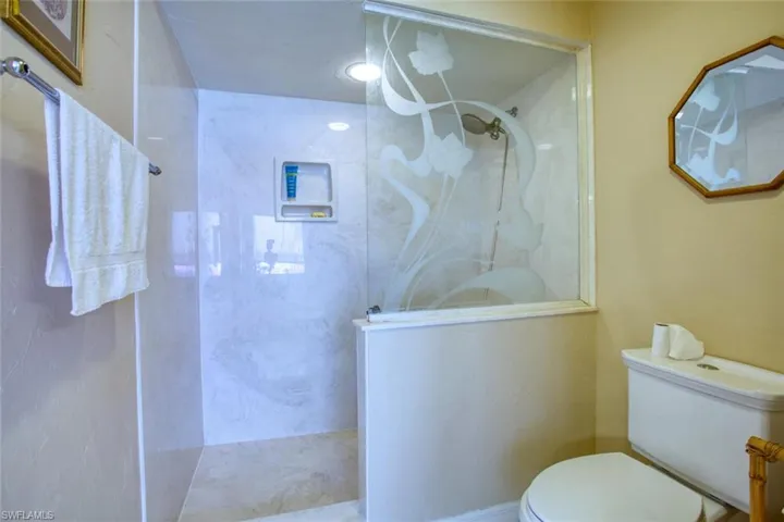 Full bath featuring toilet and walk in shower