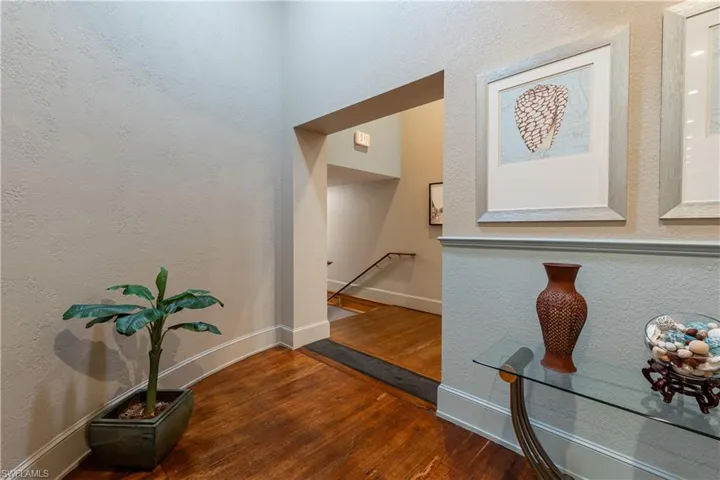 Corridor with dark hardwood / wood-style floors
