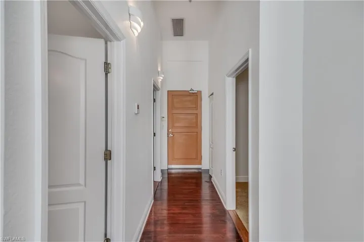 Hallway with dark wood-type flooring
