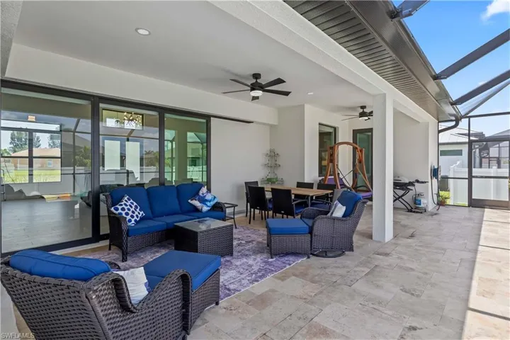 View of patio / terrace with an outdoor living space, a ceiling fan, outdoor dining space, and glass enclosure