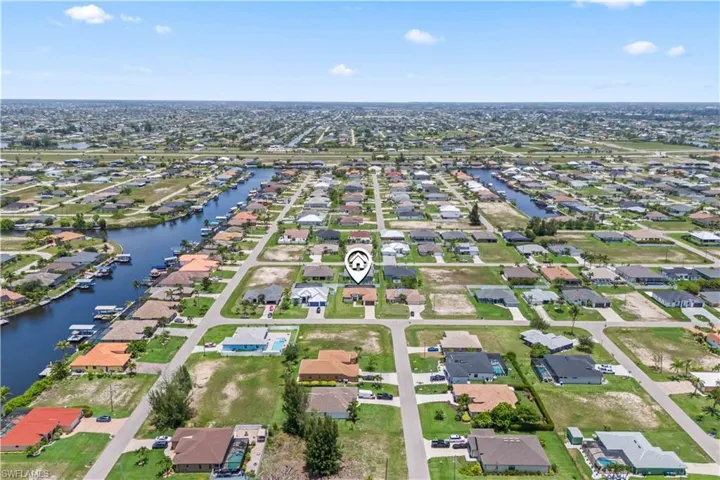 Aerial view of residential area featuring a large body of water