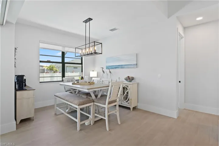 Dining room featuring light wood-type flooring and a chandelier